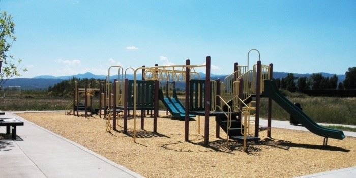 A large play area with mountains in the background.